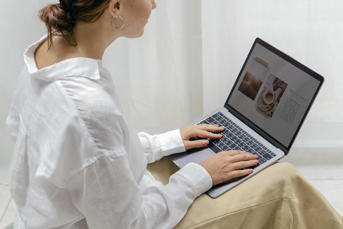 Woman using a laptop on a bean bag